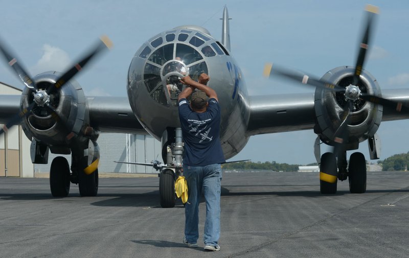 NWA Democrat-Gazette/ANDY SHUPE Rocky Smith, advance crew member and ramp boss for the Commemorative Air Force, directs the B-29 Superfortress Fiÿ, a World War II-era bomber, to stop at the Arkansas Air and Military Museum at Drake Field in Fayetteville. The Commemorative Air Force’s AirPower History Tour will be at the museum through Sunday.