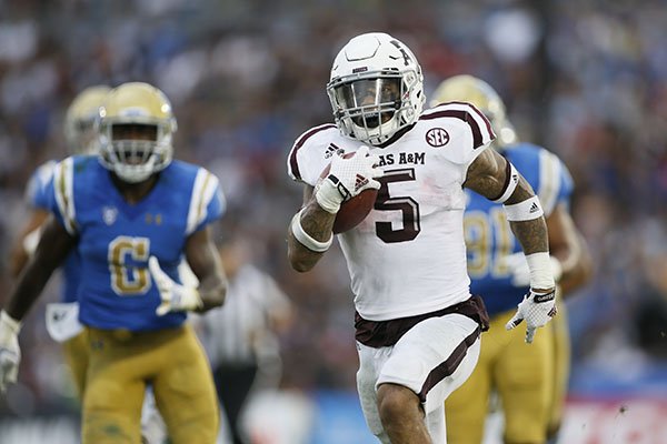 Texas A&M running back Trayveon Williams runs for a 61-yard touchdown against UCLA during the first half of an NCAA college football game, Sunday, Sept. 3, 2017, in Pasadena, Calif. (AP Photo/Danny Moloshok)

