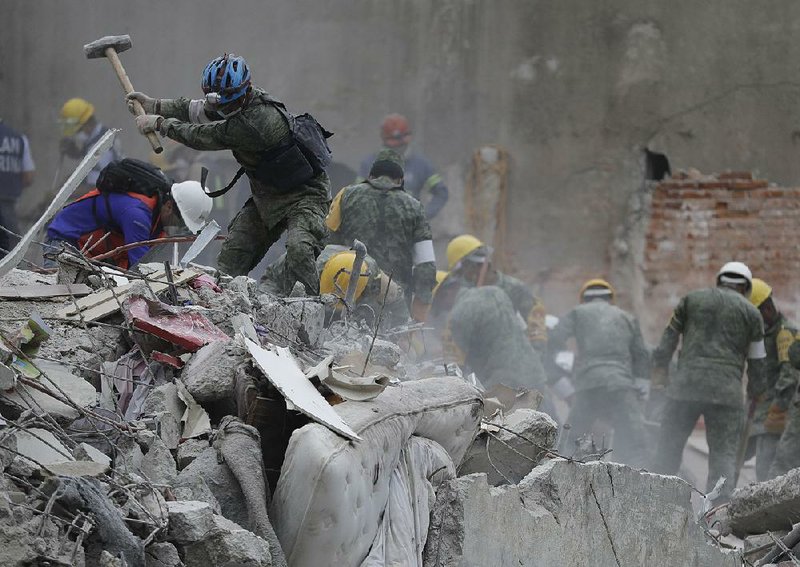 Rescuers clear rubble Thursday in the search for survivors at a collapsed apartment building in Mexico City. As recovery and rescue efforts continue after Tuesday’s devastating earthquake that killed at least 274 people, thousands left homeless are filling shelters, uncertain where they will go next but grateful for safe refuge.   