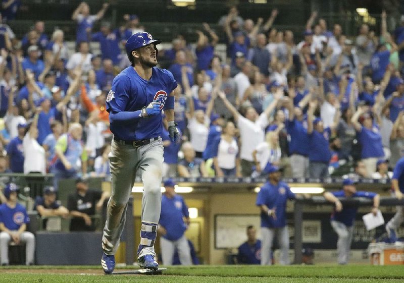 Chicago third baseman Kris Bryant watches the ball as he starts to round the bases while fans react to his two-run home run Thursday that gave the Cubs a 5-3 victory over the Milwaukee Brewers at Miller Park in Milwaukee.