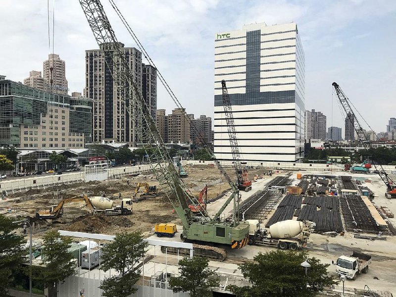 Construction crews work near the HTC headquarters building in New Taipei City, Taiwan, on Thursday.
