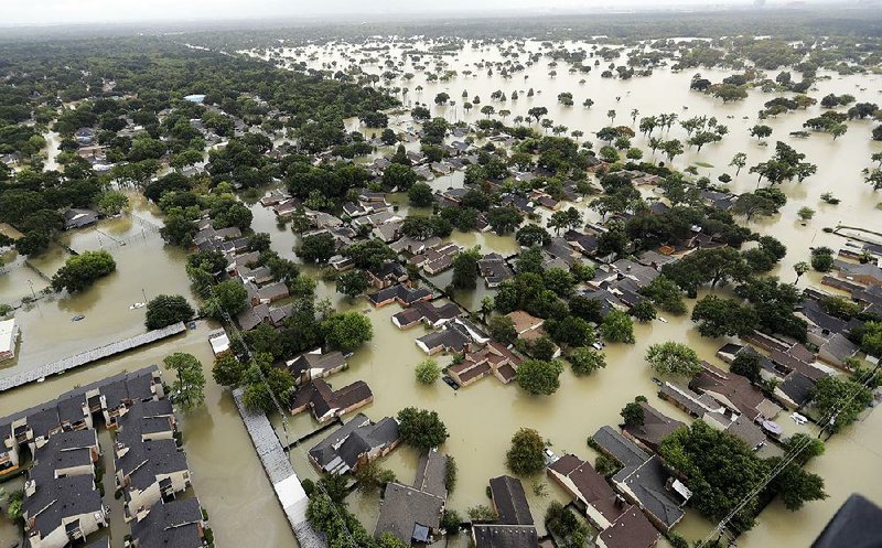 Water from Addicks Reservoir inundates a Houston neighborhood on Aug. 29. Allstate on Thursday estimated $593 million in insurance losses for August because of Hurricane Harvey.