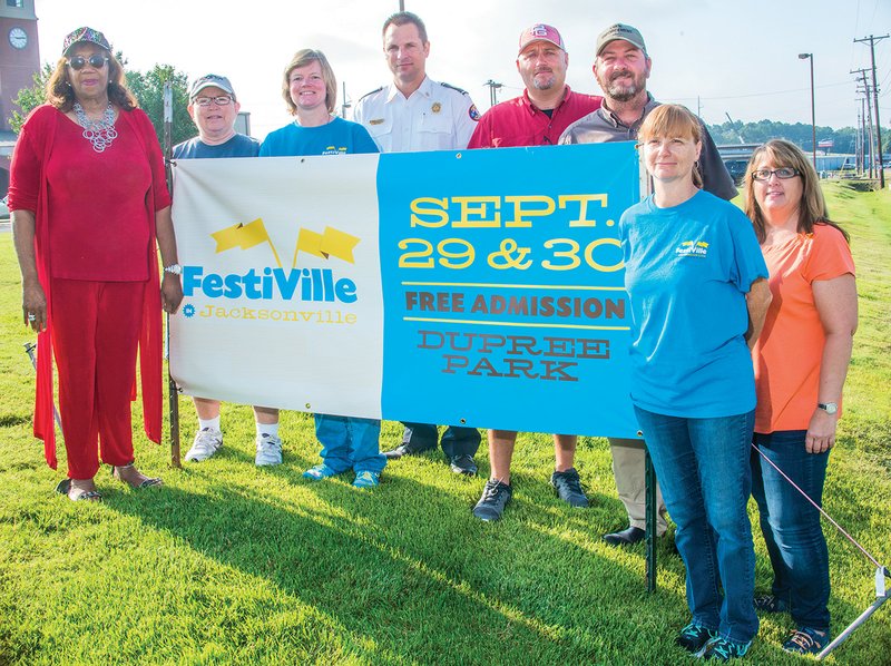 From left, Gwendolyn Harper, Jane Talent, Dana Rozenski, Alan Laughy, Kevin House, Eddie Fletcher, Jennifer Martin and Christie McMillion prepare for the upcoming FestiVille in Jacksonville, set for Friday and Saturday. Rozenski said activities at the festival will include live entertainment, a volleyball tournament, a petting zoo and pony rides, a 5K, canoe and kayak rides, a shooting demonstration, beanbag baseball, carnival rides, games, a car show and more.