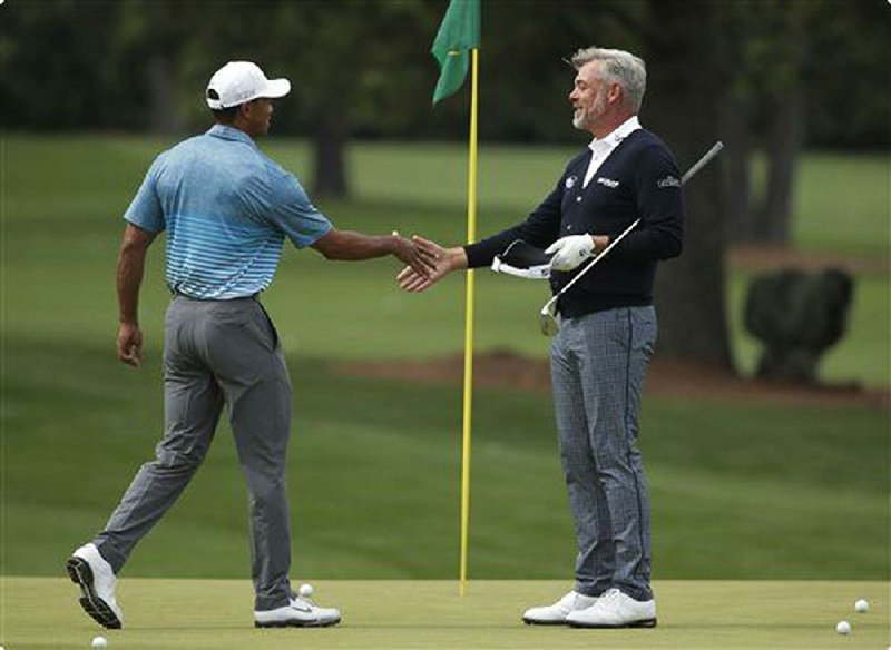 Tiger Woods (left) and Darren Clarke are friends, but Clarke recounted last week how the 14-time major champion has seldom picked up dinner tabs.