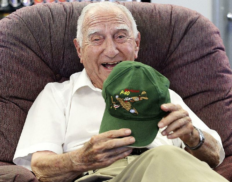 World War II veteran Charlie Ball, 94, shows off his P-40 Warhawk hat Friday. A P-40 plane similar to the one that Ball !ew during training will be taking part in today’s air show in North Little Rock. 