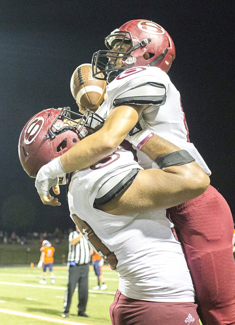 Springdale High’s Sebastian Barranco (14) celebrates Friday after recovering a fumble late in the fourth against Rogers Heritage in Rogers.