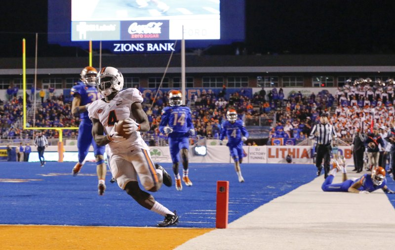 Virginia running back Olamide Zaccheaus (4) scores a touchdown during the second half of an NCAA college football game against Boise State in Boise, Idaho, Friday, Sept. 22, 2017. Virginia won 42-23. 