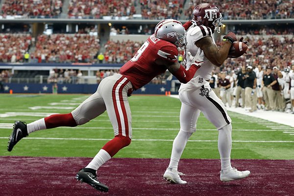 Arkansas defensive back Santos Ramirez (9) defends as Texas A&M wide receiver Christian Kirk (3) catches a pass in the end zone for a touchdown during overtime of an NCAA college football game, Saturday, Sept. 23, 2017, in Arlington, Texas. Texas A&M won 50-43. (AP Photo/Tony Gutierrez)

