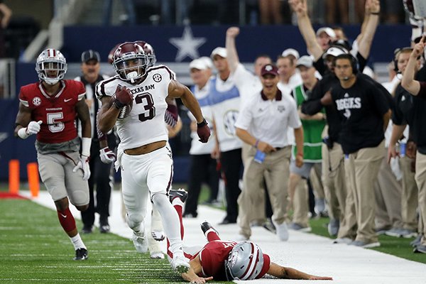 Texas A&M wide receiver Christian Kirk (3) evades Arkansas tackles on a 100-yard kick-off return for a touchdown in the second half of an NCAA college football game, Saturday, Sept. 23, 2017, in Arlington, Texas. (AP Photo/Tony Gutierrez)

