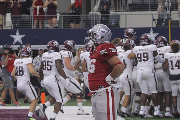 Arkansas tight end Cheyenne O'Grady watches as Texas A&M players celebrate a 50-43 overtime win on Saturday, Sept. 23, 2017, in Arlington, Texas. 