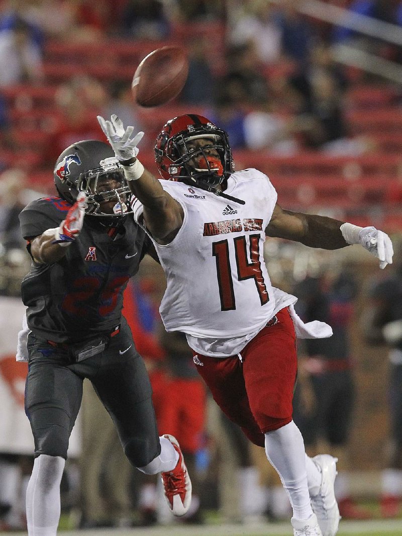 Arkansas State receiver Chris Murray (14) attempts to haul in a pass while SMU’s Justin Guy-Robinson reaches to knock down the ball Sept. 23 in Dallas.