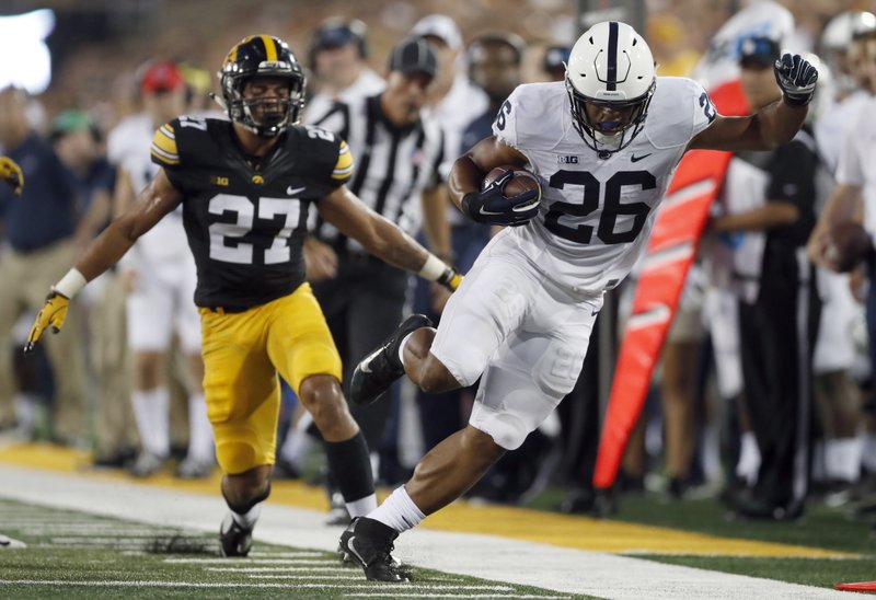 Penn State running back Saquon Barkley, right, is unable to stay in bounds as Iowa defensive back Amani Hooker watches during the first half of an NCAA college football game Saturday, Sept. 23, 2017, in Iowa City, Iowa. (AP Photo/Jeff Roberson)
