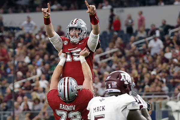 Arkansas offensive lineman Frank Ragnow lifts quarterback Cole Kelley, top, as the celebrate a touchdown against Texas A&M in the first half of an NCAA college football game, Saturday, Sept. 23, 2017, in Arlington, Texas. (AP Photo/Tony Gutierrez)

