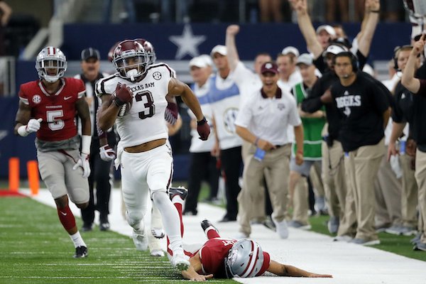 Texas A&M wide receiver Christian Kirk (3) evades Arkansas tackles on a 100-yard kick-off return for a touchdown in the second half of an NCAA college football game, Saturday, Sept. 23, 2017, in Arlington, Texas. (AP Photo/Tony Gutierrez)