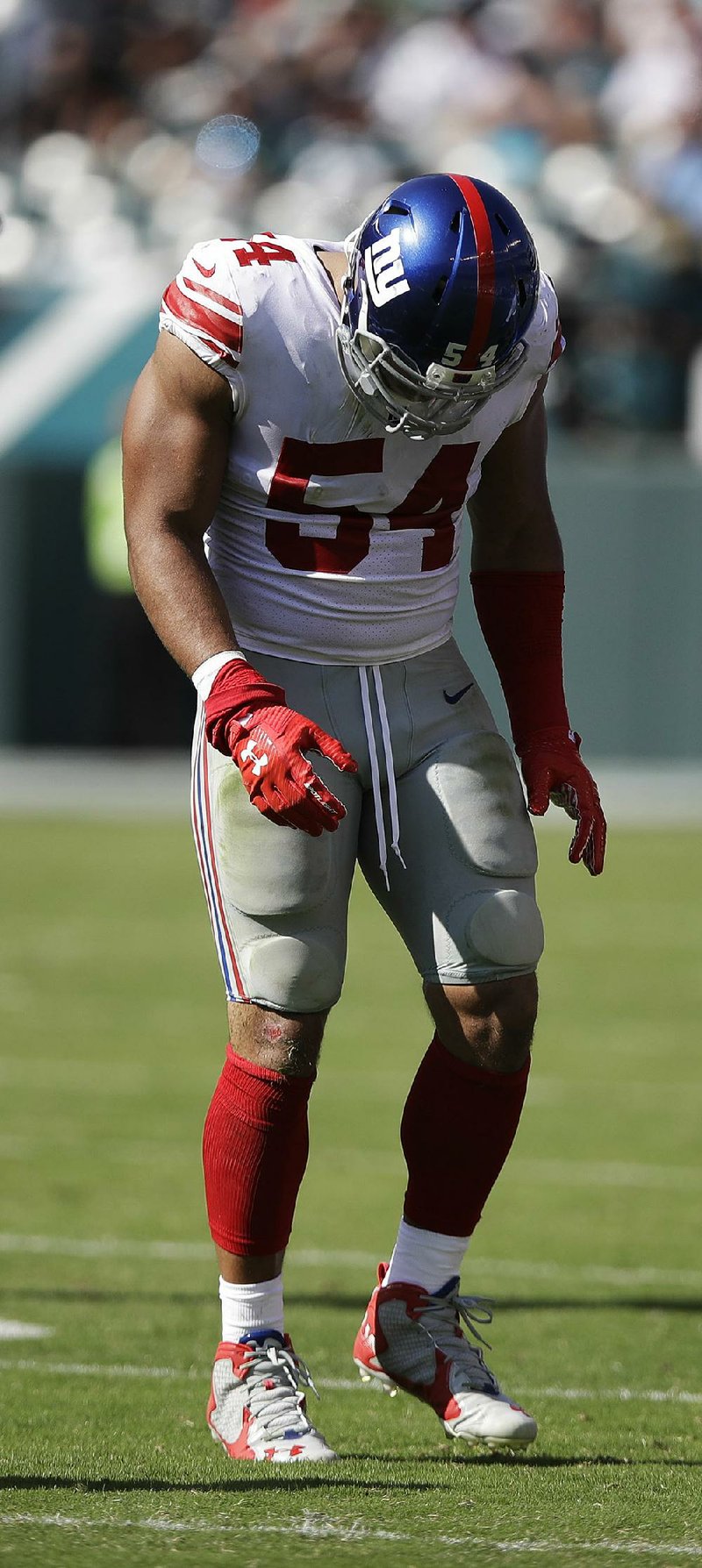 New York Giants’ Olivier Vernon hobbles off the field with an ankle injury in Sunday’s game in Philadelphia.