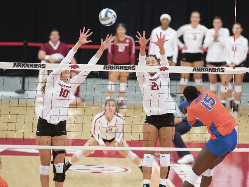 Arkansas' Kelly O'Brien (10) and Pilar Victoria can't stop the shot by Florida's Shainah Joseph Sunday Sept. 24, 2017 at Barnhill Arena in Fayetteville. Florida won the match in three sets. 