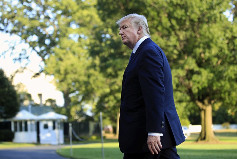 President Donald Trump walks towards the White House in Washington, Sunday, Sept. 24, 2017, after speaking to reporters upon his return. Citizens of eight countries will face new restrictions on entry to the U.S. under a proclamation signed by Trump on Sunday. 