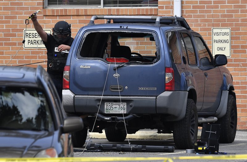 Police investigate the scene outside the Burnette Chapel Church of Christ after a deadly shooting at the church Sunday in Antioch, Tenn.