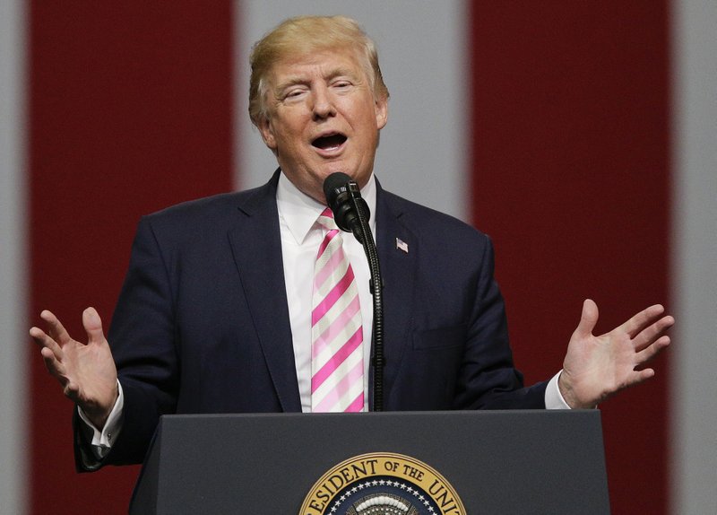 In this Sept. 22, 2017, photo President Donald Trump speaks at a campaign rally in Huntsville, Ala. Trump says he wants to lure Democratic lawmakers to sign on to a Republican-crafted tax overhaul plan. But negotiators must grapple with the reality that any handouts to Democrats quickly could turn into turn-offs for the GOP. (AP Photo/Brynn Anderson)