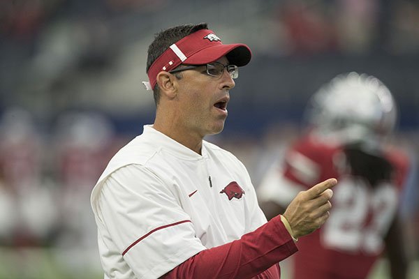 Arkansas offensive coordinator Dan Enos watches warmups prior to a game against Texas A&M on Saturday, Sept. 23, 2017, in Arlington, Texas. 