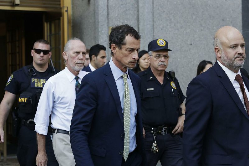 Former U.S. Rep. Anthony Weiner (center) leaves federal court Monday after his sentencing.
