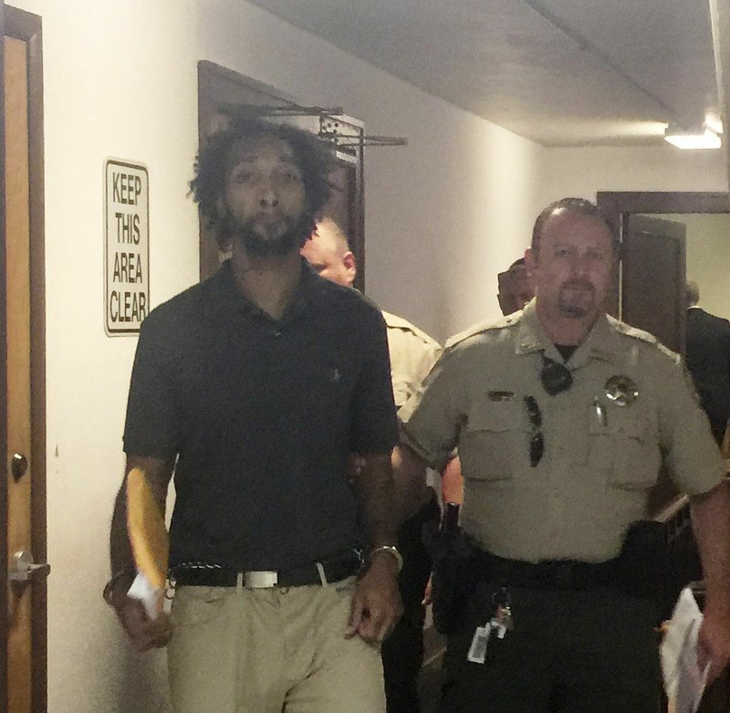 NWA Democrat-Gazette/TRACY M. NEAL Terrance Billups, 37, is escorted Monday from the courtroom after being sentenced to 25 years in prison for stabbing a woman.