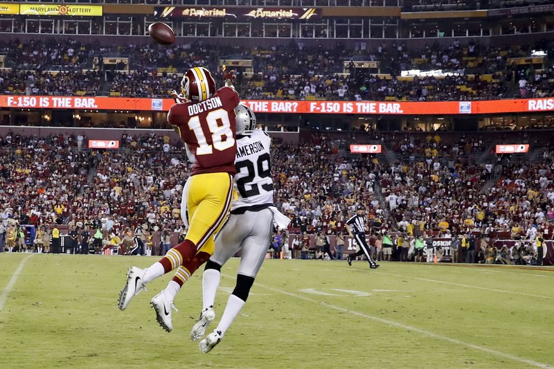 Washington Redskins wide receiver Josh Doctson (18) pulls in a touchdown pass under pressure form Oakland Raiders cornerback David Amerson (29) during the second half of an NFL football game in Landover, Md., Sunday, Sept. 24, 2017. 