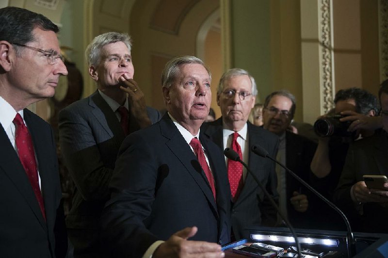Sen. Lindsey Graham (center), with Sen. Bill Cassidy (left) and Senate Majority Leader Mitch McConnell, said Tuesday that the repeal effort will continue. “We’re going to fulfill our promise,” Graham said. “It took 18 months to pass Obamacare. It’s going to take a while to repeal it.”  