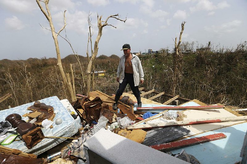 Jose Trinidad walks through the remnants of his home in Montebello, Puerto Rico, on Tuesday, five days after Hurricane Maria left the island devastated. 
