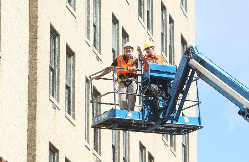 Arlington Resort Hotel & Spa owner Al Rajabi, right, and Cromwell Architects & Engineer Director of Engineering Joe Hilliard do a visual inspection of the exterior of the Arlington Resort Hotel & Spa Tuesday, September 26, 2017. (The Senitnel-Record/Richard Rasmussen)