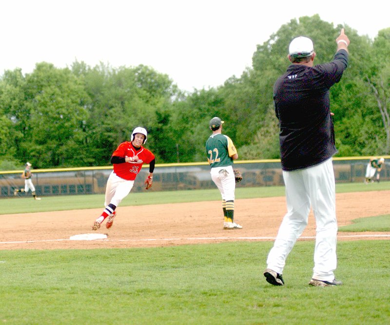 MARK HUMPHREY ENTERPRISE-LEADER Farmington baseball coach Jay Harper signals another base runner as Kelton Price rounds third during the Cardinals&#8217; 6-0 win over Alma, 6-0, in April. Price received All-Conference 5A West honors.