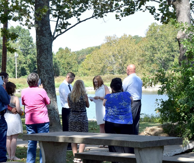 Photo by Mike Eckels With Crystal Lake serving as a backdrop, friends and family gathered in the park to witness Molly Thomas and Ashton Sisson exchange wedding vows Sept. 13. Decatur Mayor and former justice of the peace Bob Tharp performed the service.