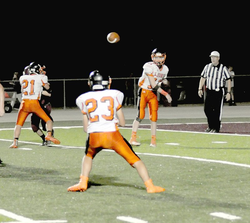 MARK HUMPHREY ENTERPRISE-LEADER/Gravette quarterback Cy Hilger completes a short pass to Trenton Durham at Lincoln Thursday, Sept. 21. The junior Lions upstaged Lincoln, 28-26, with a last-second score.