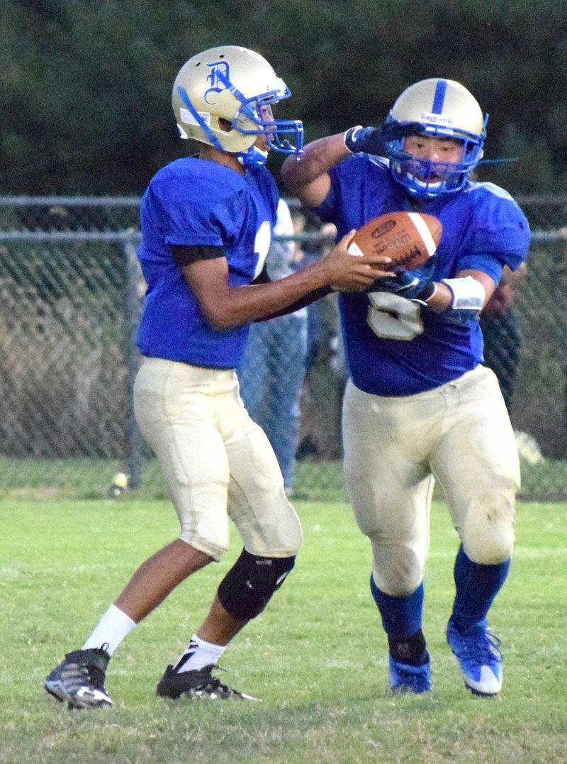 Photo by Mike Eckels Alex Lee (Decatur 5) received a handoff from Joseph Armstrong (left) during the first quarter of the Decatur-Mountainburg football contest at Bulldog Stadium in Decatur Sept. 22. The Dragons defeated the Bulldogs, 55-7, in the first conference matchup of the 2017 season.