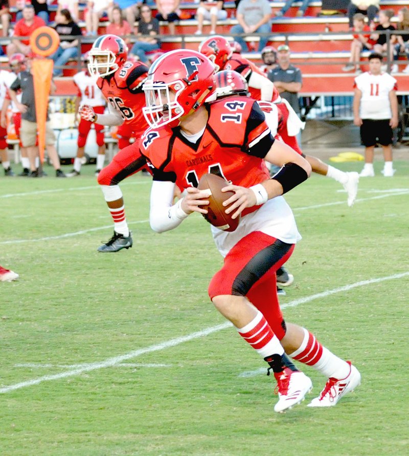 MARK HUMPHREY ENTERPRISE-LEADER Farmington senior quarterback Trey Waggle picks up good yardage on this carry. He ran six times for 20 yards and passed for 218 yards and 2 touchdowns on 9 of 13 passing. Waggle guided the Cardinals to touchdowns on their first five possessions in Friday&#8217;s 61-41 Homecoming victory over Clarksville.