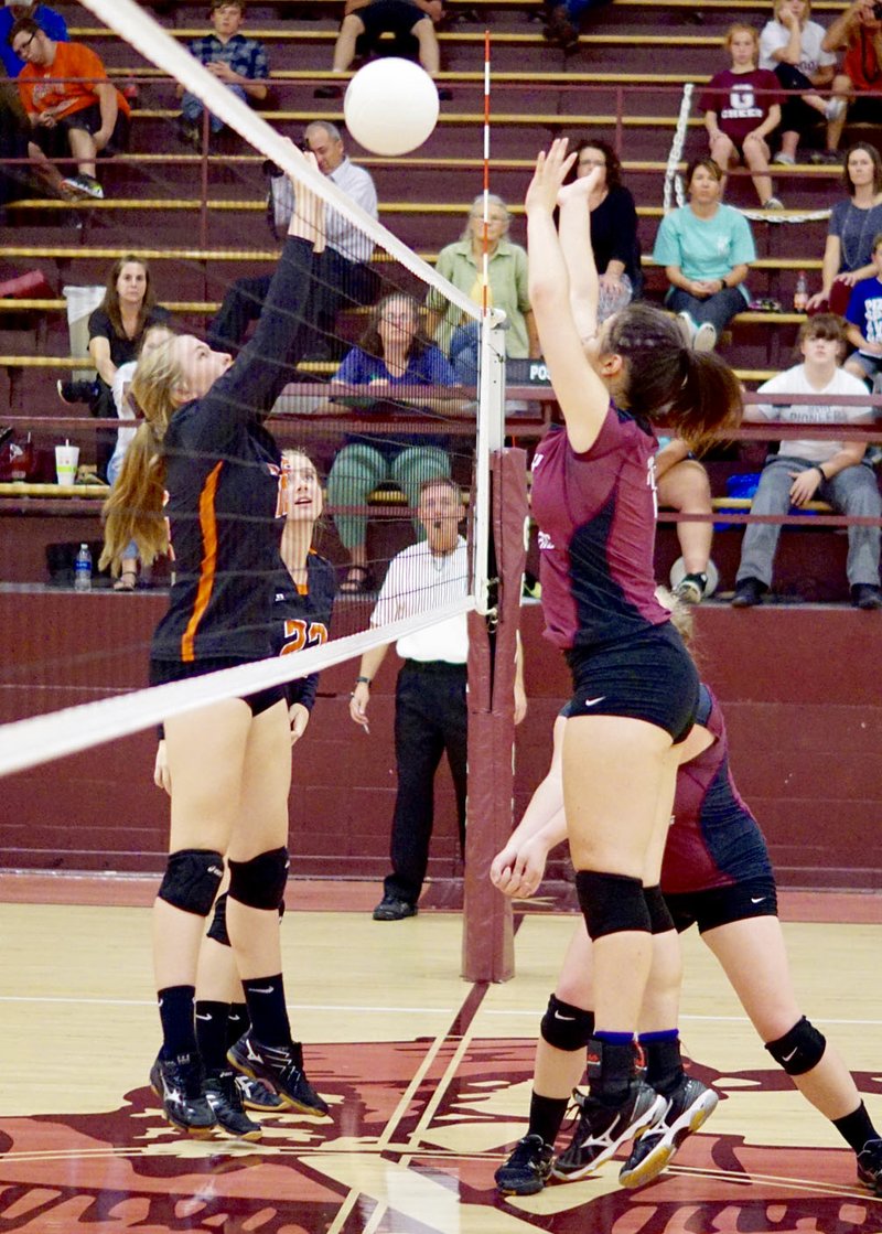 Photo by Randy Moll Gravette&#8217;s Allie Callahan and Brooklyn Lykins battle at the net against Gentry&#8217;s Hannah Boss and Natalie Robinson during play between the two teams in Gentry on Sept. 19.