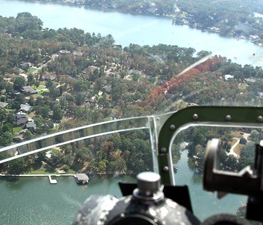The Sentinel-Record/Grace Brown BIRD'S EYE VIEW: Lake Hamilton, left, as seen from the nose of the 1944 B-17 bomber Sentimental Journey as it flies over the city on Monday.