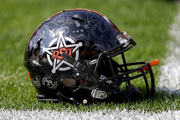 An Oklahoma State football helmet is on the turf during warmups before an NCAA football game against Pittsburgh, Saturday, Sept. 16, 2017, in Pittsburgh. (AP Photo/Keith Srakocic)

