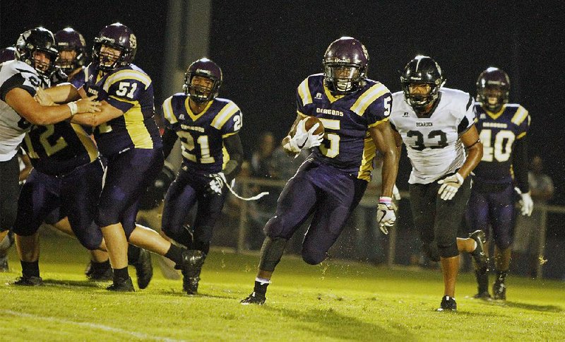 Junction City’s Hishmma Taylor (5) runs the ball against Bearden on Sept. 1. Taylor has rushed for 911 yards and scored 11 touchdowns to help the Dragons to a 4-0 start.  