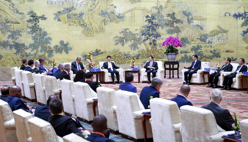 In this Sept.26, 2017 photo provided by China's Xinhua News Agency, Meng Jianzhu, a member of the Political Bureau of the Communist Party of China (CPC) Central Committee and head of the Commission for Political and Legal Affairs of the CPC Central Committee, meets with the 86th Interpol General Assembly participants in Beijing, China. International police agency Interpol voted Wednesday, Sept. 27, to include Palestine as a member state, in a new boost to Palestinian efforts for international recognition and influence amid long-stalled negotiations with Israel for full statehood.(Zhang Ling/Pool Photo via AP)