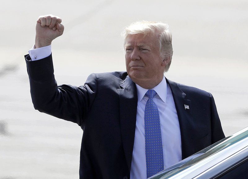 President Donald Trump pumps his fist to guests after arriving on Air Force One, Wednesday, Sept. 27, 2017, in Indianapolis. (AP Photo/Darron Cummings)