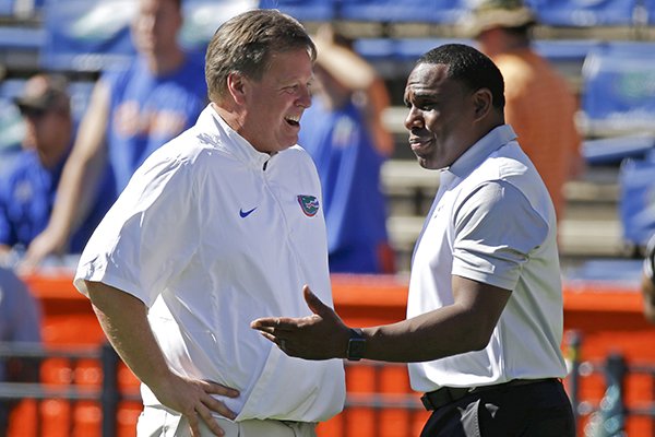 Florida head coach Jim McElwain, left, greets Vanderbilt head coach Derek Mason on the field before an NCAA college football game, Saturday, Nov. 7, 2015, in Gainesville, Fla. (AP Photo/John Raoux)

