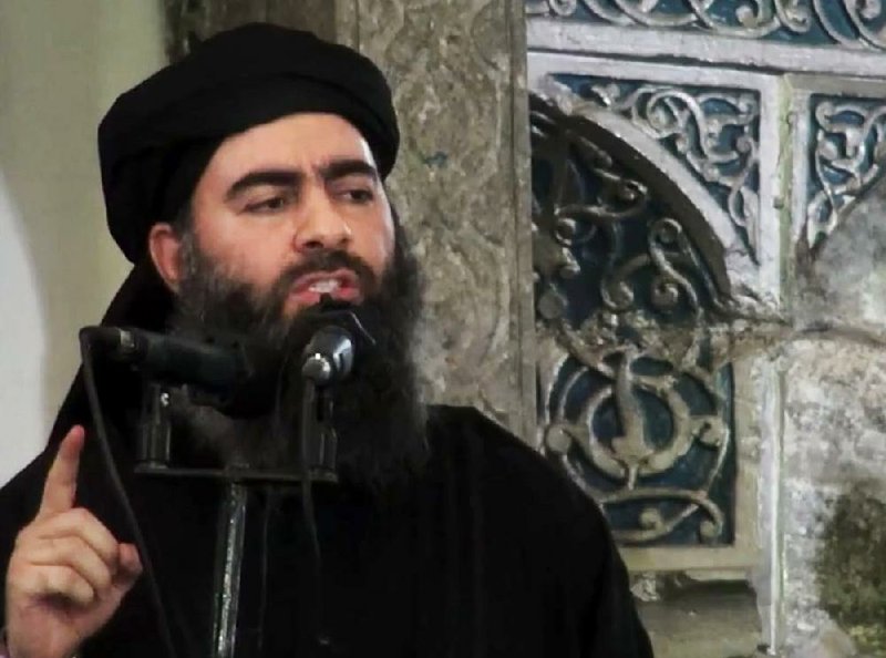 This file image taken from video and posted on a militant website on July 5, 2014, purports to show the leader of the Islamic State group, Abu Bakr al-Baghdadi, delivering a sermon at a mosque in Iraq during his first public appearance. The Islamic State group on Thursday released a purported audio recording from al-Baghdadi. 