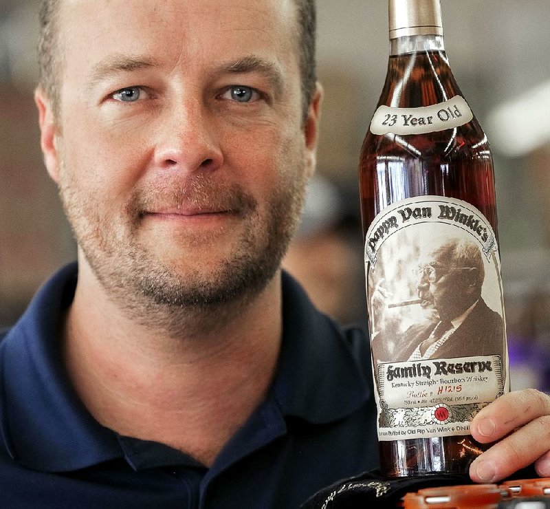 John Crow, owner of 107 Liquor in Sherwood, brandishes the bottle of 23-year-reserve Pappy van Winkle Family Reserve bourbon he’s donating for the raffle at Fountain Fest, Oct. 19 at the Arkansas Arts Center.