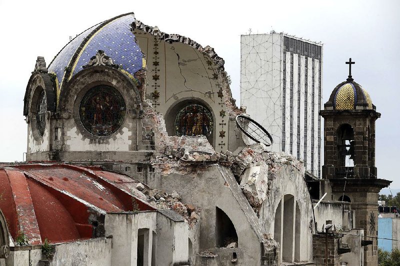 The damaged dome of Our Lady of Angels Church is seen from an adjacent rooftop in the Guerrero neighborhood of Mexico City. Cracks crisscrossed the dome, and stone from the roof continued to fall onto the church’s wooden pews in the aftermath of the 7.1-magnitude earthquake last week. On Sunday, the cupola split and part of it crashed to the floor. 