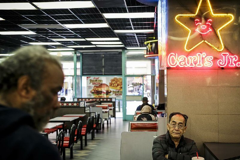 Customers at a Carl’s Jr. location in Los Angeles wait for their orders to arrive. 