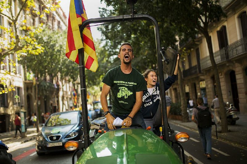 Catalan farmers drive tractors in Barcelona during a rally in support of an independence referendum for the Catalonia region. 