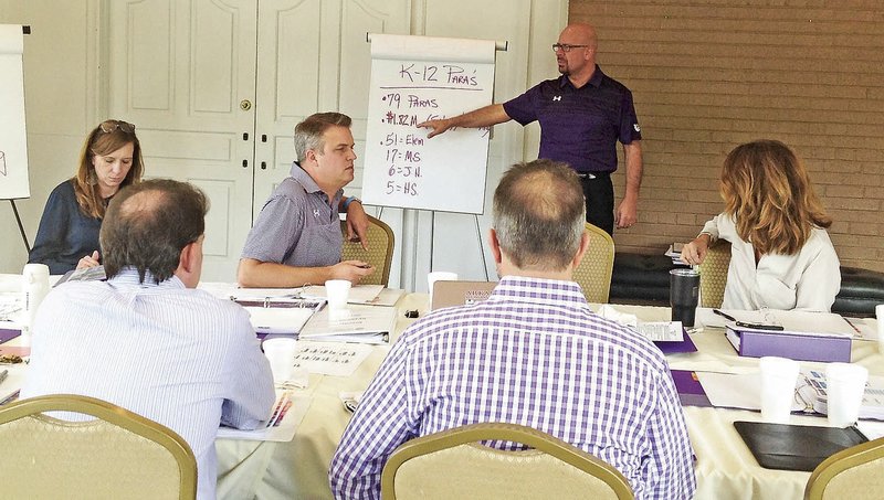 NWA Democrat-Gazette/DAVE PEROZEK Matthew Wendt, superintendent of the Fayetteville School District, leads the School Board in a discussion on Friday during a board retreat meeting at the Fayetteville Country Club.