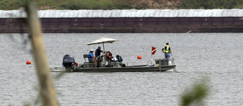 In this Sept. 13, 2017 photo, a boat with a dive flag is shown at San Jacinto River Waste Pits near the Interstate 10 bridge over the river in Channelview, Texas. The Environmental Protection Agency says an unknown amount of a dangerous chemical linked to birth defects and cancer may have washed downriver from a Houston-area Superfund site during the flooding from Hurricane Harvey. (AP Photo/David J. Phillip)