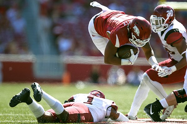 Arkansas running back Devwah Whaley is tackled by New Mexico State defensive back Jacob Nwanga during a game Saturday, Sept. 30, 2017, in Fayetteville. 